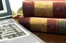 Two traditional legal books next to a computer laptop