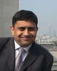 Photo of Sanjay Morzaria with the London skyline in the background