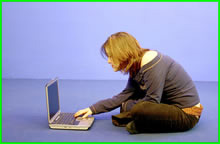 Lady sitting on the floor using a laptop